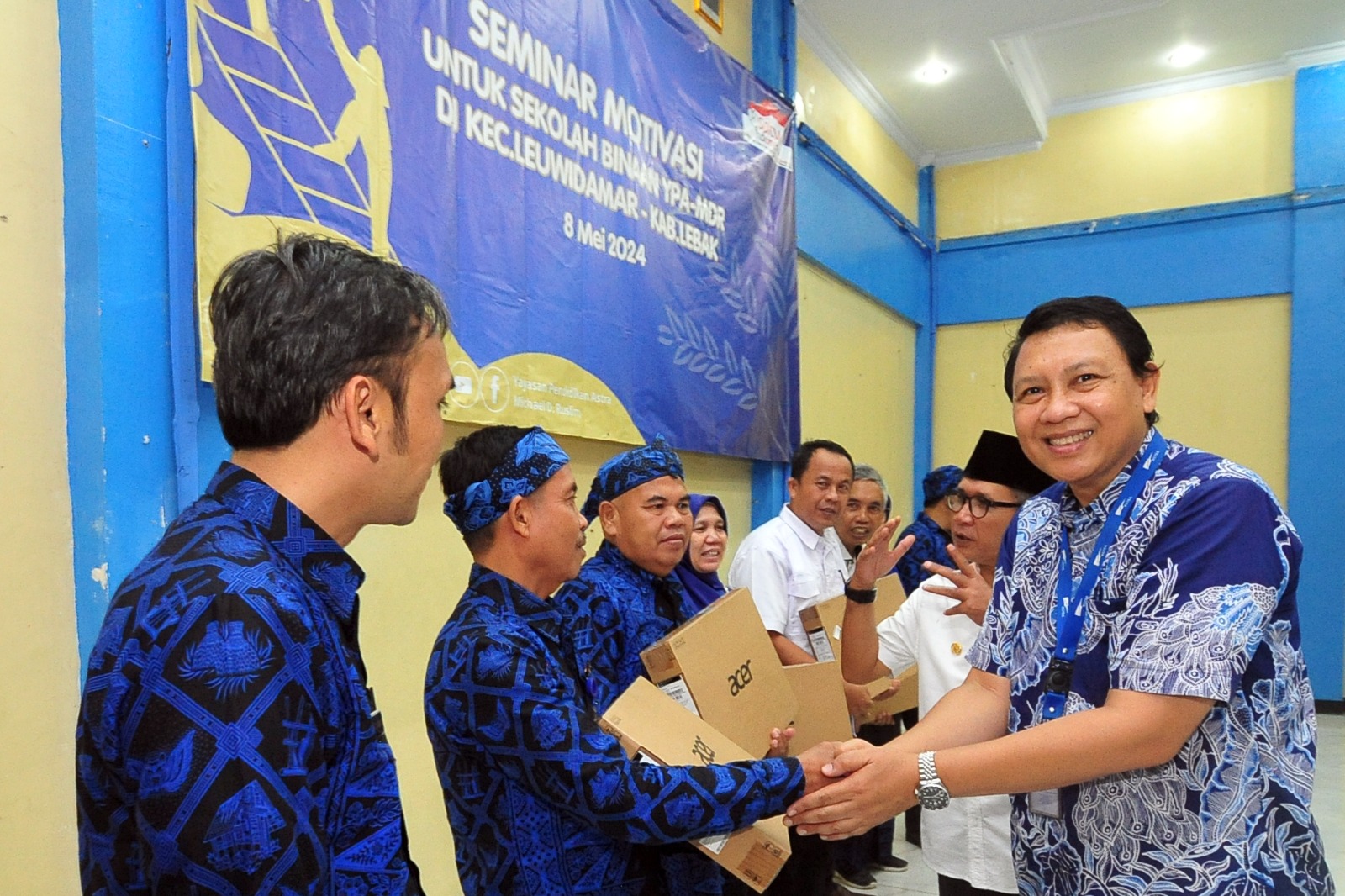 Bendahara Pengurus YPA-MDR, Agung Kurniawan menyerahkan secara simbolis bantuan laptop kepada 13 sekolah binaan YPA-MDR. foto : Ist